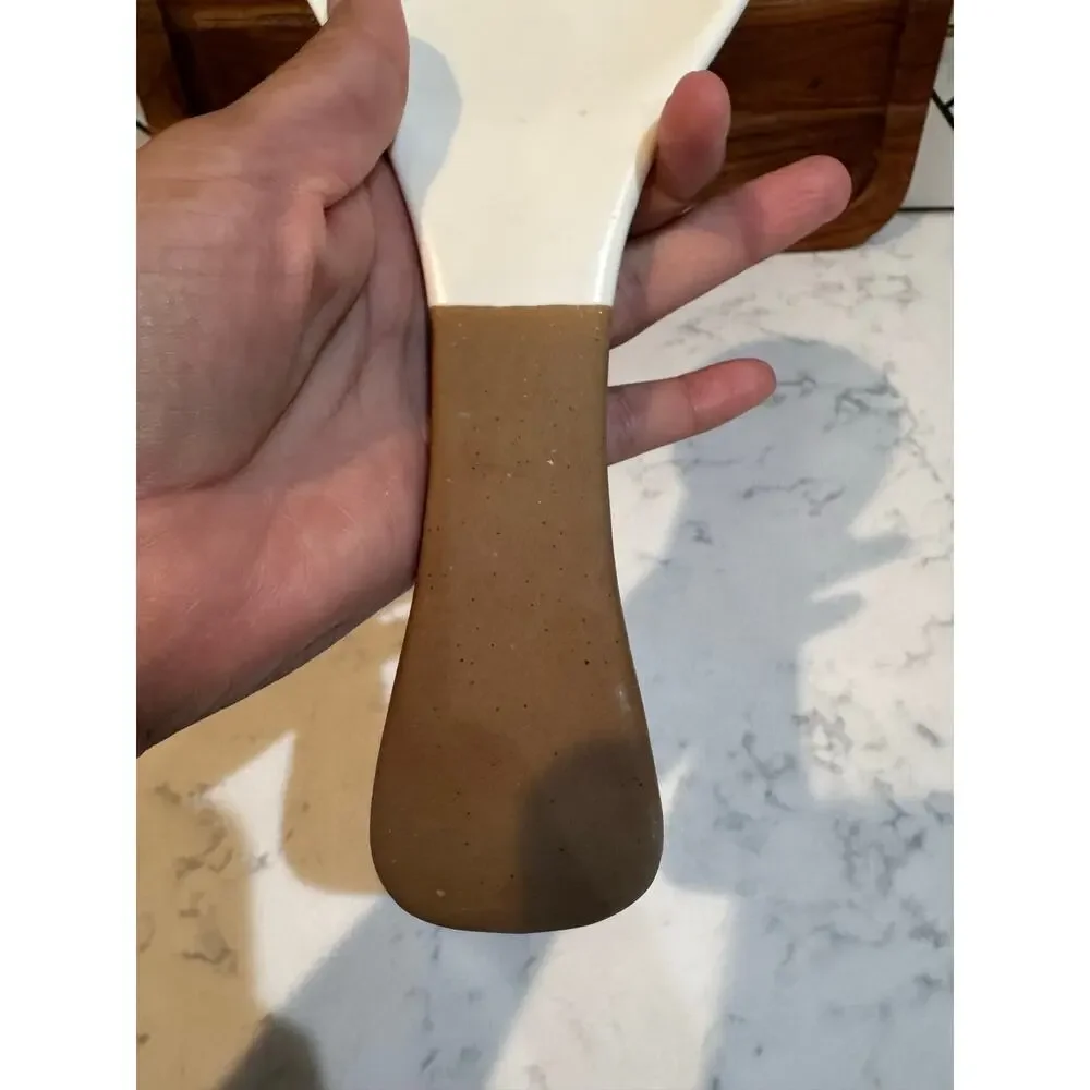white ceramic spoon rest black bee graphic contrasting brown dipped handle